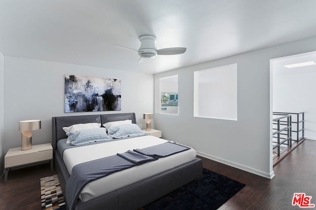 bedroom with dark hardwood / wood-style floors and ceiling fan