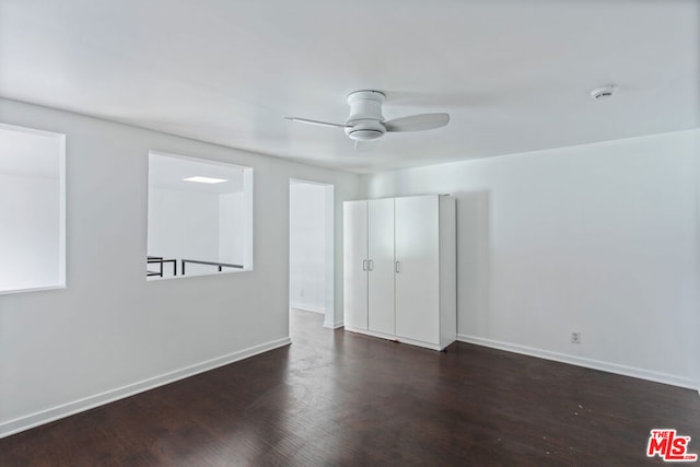 unfurnished room with ceiling fan and dark hardwood / wood-style floors