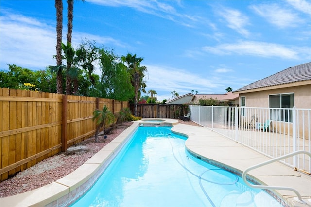 view of swimming pool featuring a patio area and an in ground hot tub