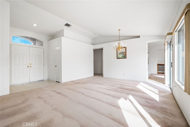 interior space with a chandelier, vaulted ceiling, and a healthy amount of sunlight