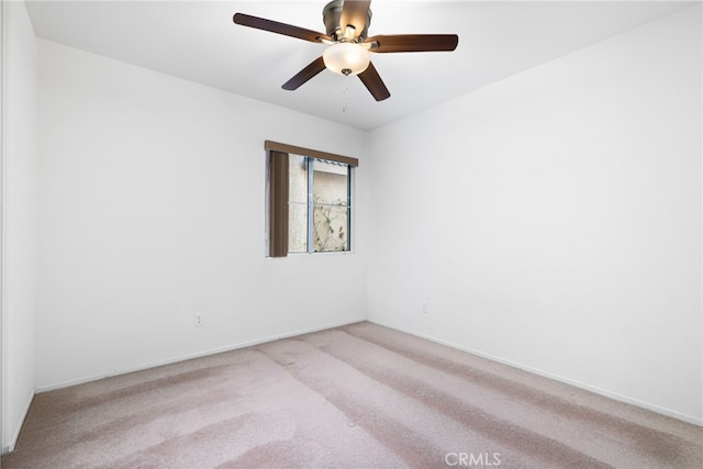 spare room with light carpet and ceiling fan