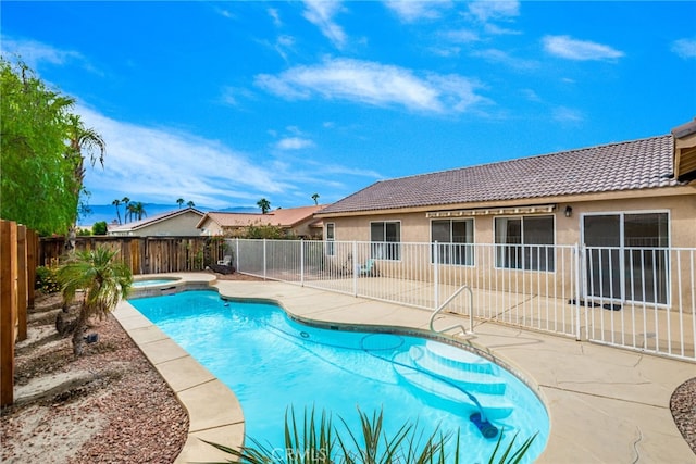 view of swimming pool featuring an in ground hot tub and a patio