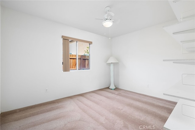 unfurnished room featuring light colored carpet and ceiling fan