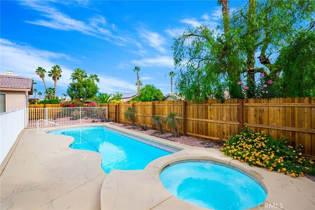 view of swimming pool featuring an in ground hot tub