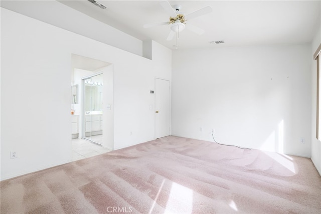 carpeted spare room featuring ceiling fan