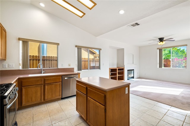 kitchen with a center island, stainless steel appliances, plenty of natural light, and sink