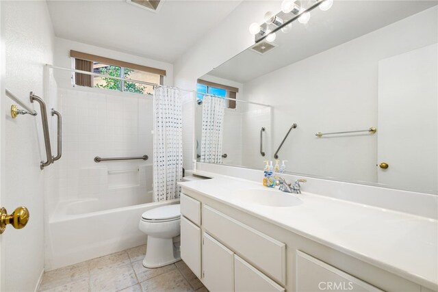 full bathroom with tile patterned flooring, vanity, shower / tub combo, and toilet