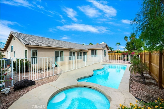 view of pool featuring an in ground hot tub and a patio