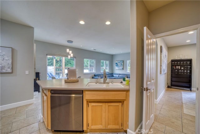 kitchen featuring dishwasher, light brown cabinetry, light tile patterned floors, and sink