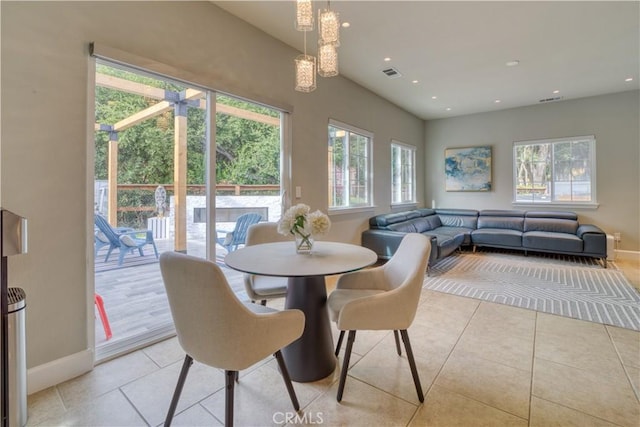 dining space with plenty of natural light and light tile patterned floors