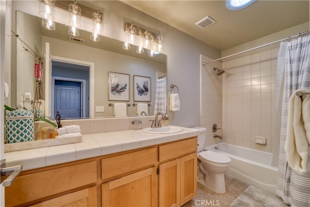 full bathroom with tile patterned floors, shower / bath combo, toilet, and vanity