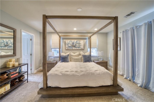 bedroom with light carpet and multiple windows