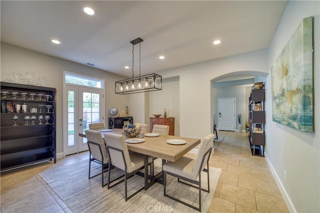 tiled dining area featuring french doors