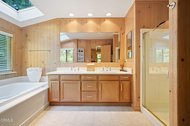 bathroom with plus walk in shower, vanity, wooden walls, and vaulted ceiling with skylight