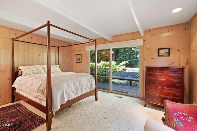 bedroom featuring carpet, access to exterior, wooden walls, and beamed ceiling