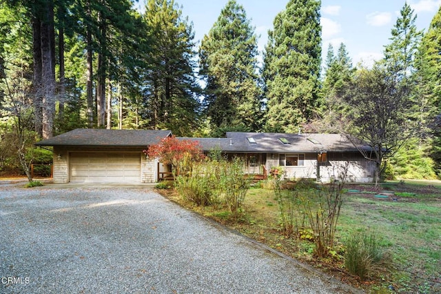 single story home with driveway and a garage