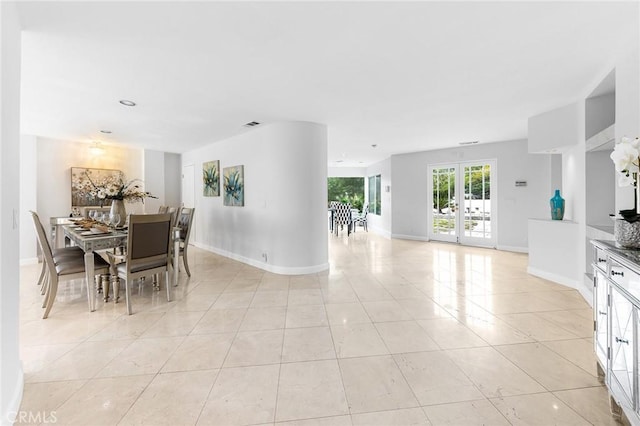 dining space featuring light tile patterned floors