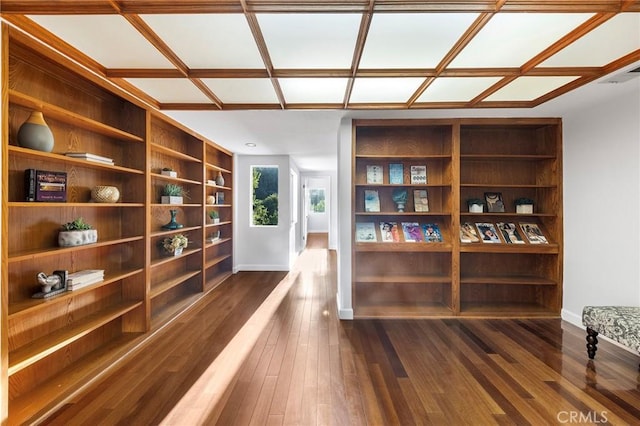 interior space with dark hardwood / wood-style flooring, built in features, and coffered ceiling