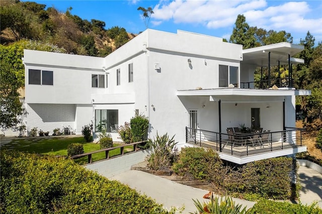 back of house with a balcony