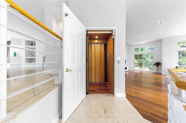 hallway with light hardwood / wood-style flooring