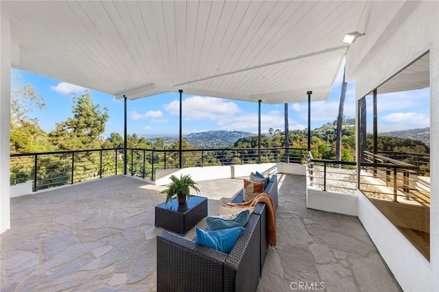 sunroom / solarium featuring a mountain view