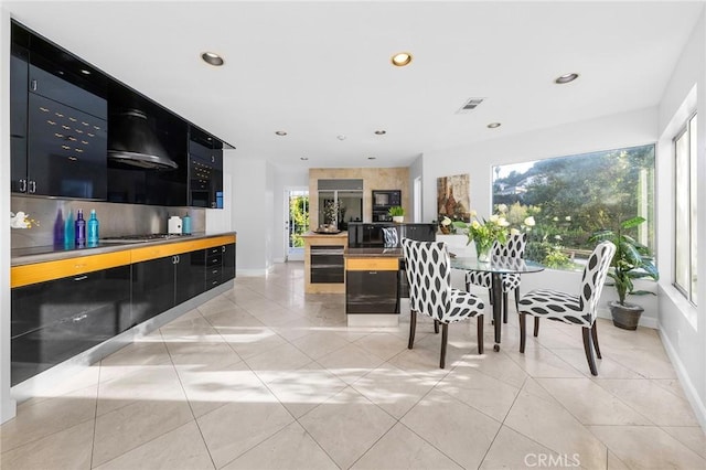 tiled dining space with wine cooler and a wealth of natural light