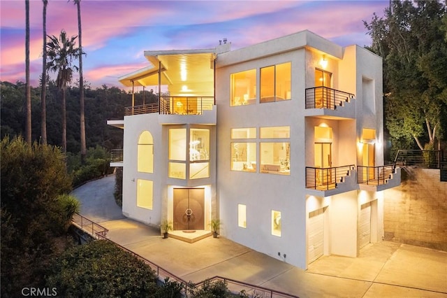 view of front of property with a balcony and a garage