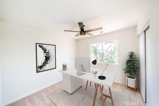 home office featuring ceiling fan and light colored carpet