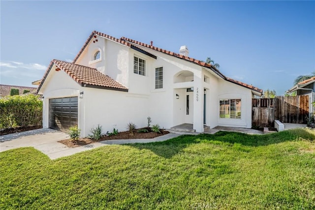 view of front of property featuring a front lawn and a garage