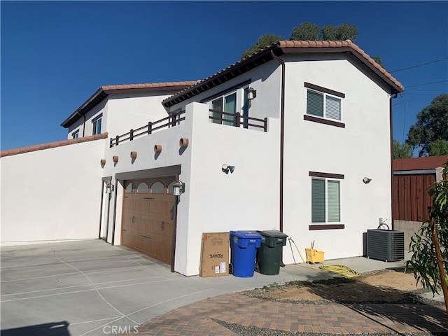 exterior space with cooling unit and a garage