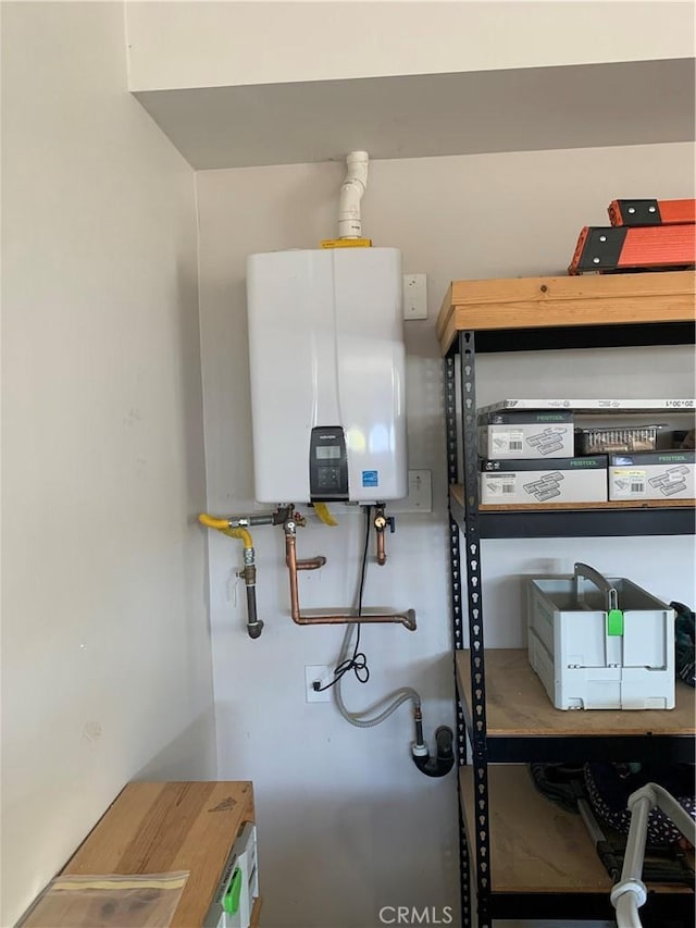 utility room featuring water heater