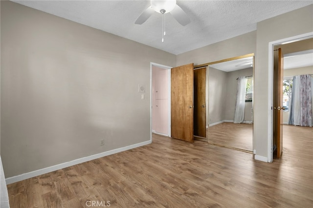 8653 Norwood Pl, Rosemead, CA 91770 - unfurnished bedroom with wood finished floors, baseboards, a closet, a ceiling fan, and a textured ceiling