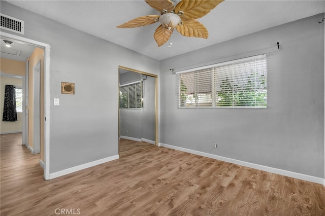 8653 Norwood Pl, Rosemead, CA 91770 - unfurnished bedroom featuring a closet, baseboards, wood finished floors, and multiple windows