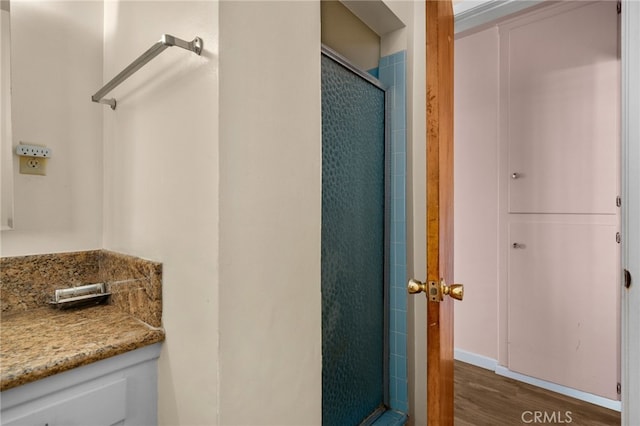 bathroom with wood-type flooring and walk in shower