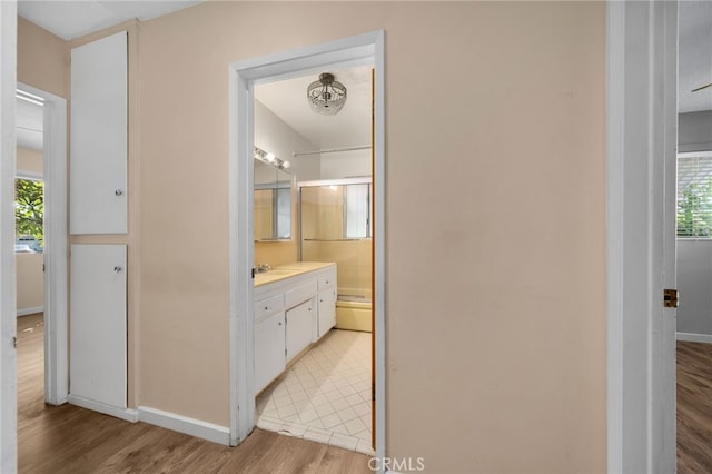 8653 Norwood Pl, Rosemead, CA 91770 - bathroom with wood finished floors, vanity, baseboards, and a shower