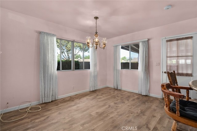 interior space featuring an inviting chandelier and hardwood / wood-style flooring