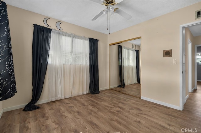 spare room with wood-type flooring, a textured ceiling, and ceiling fan