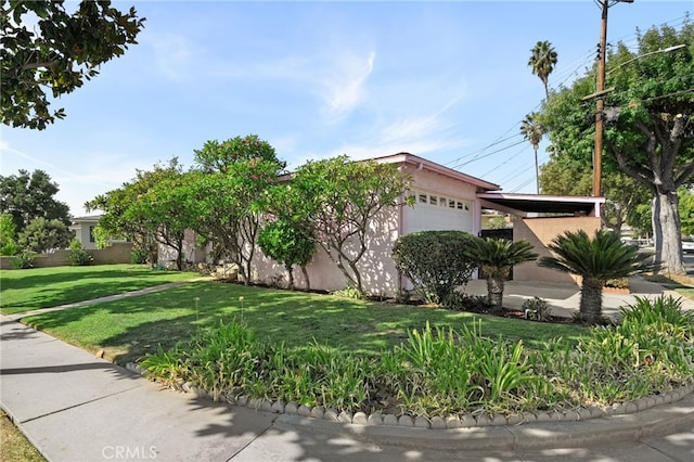 8653 Norwood Pl, Rosemead, CA 91770 - view of property hidden behind natural elements with a garage, a front lawn, and stucco siding