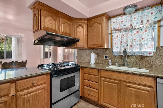 8653 Norwood Pl, Rosemead, CA 91770 - kitchen with stainless steel appliances, exhaust hood, a sink, dark stone counters, and tasteful backsplash