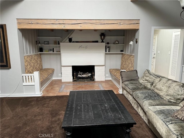 unfurnished living room with tile patterned floors and a brick fireplace