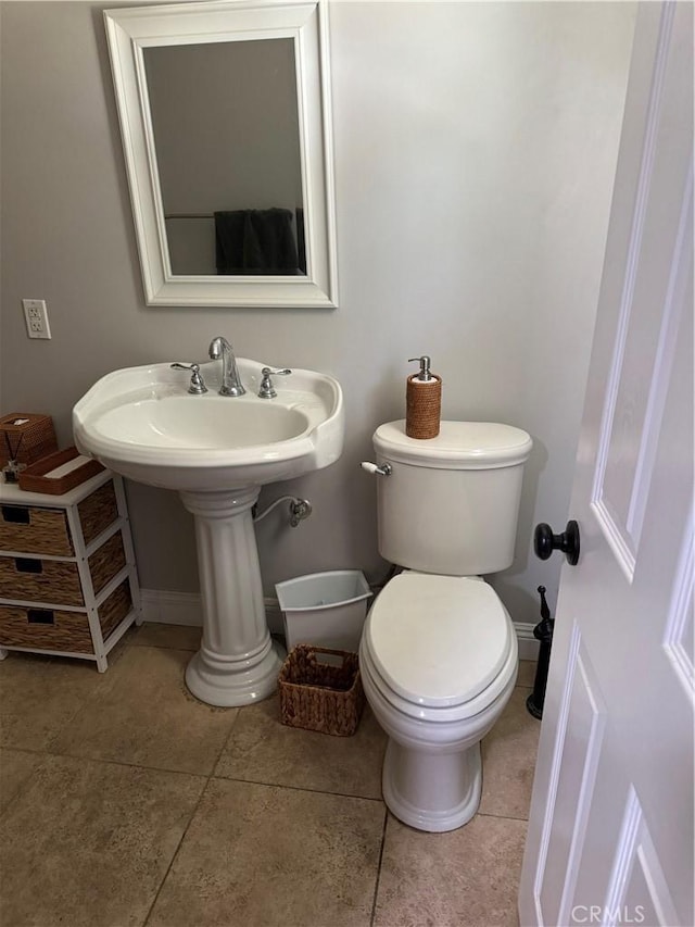 bathroom featuring toilet and tile patterned floors