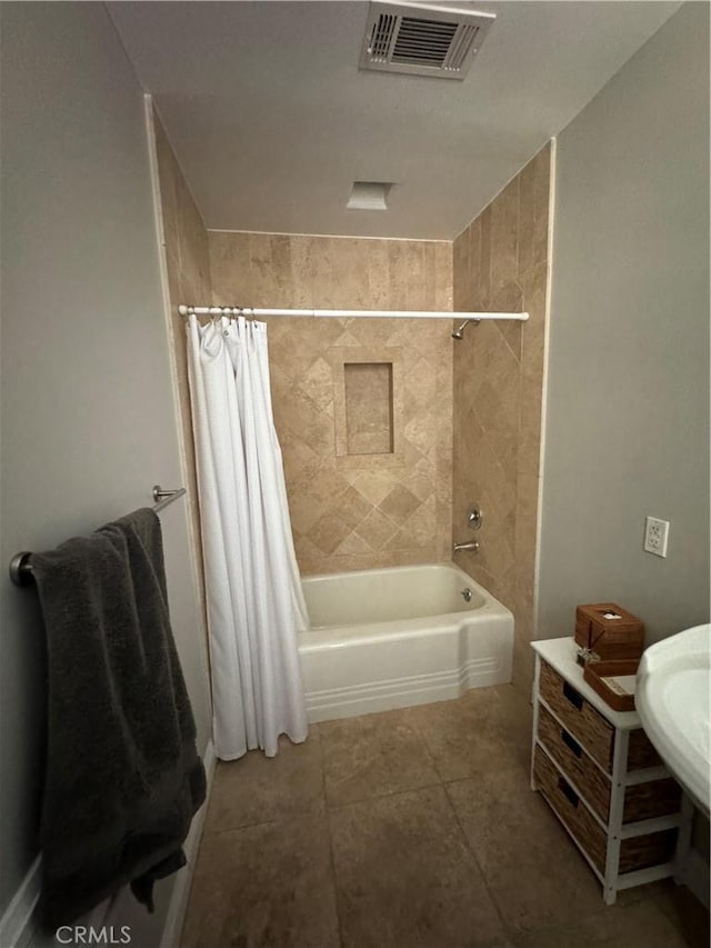 bathroom featuring tile patterned flooring and shower / tub combo with curtain