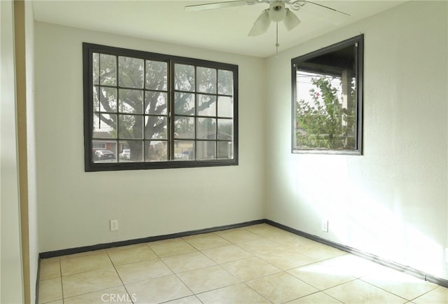 spare room featuring light tile patterned floors and ceiling fan