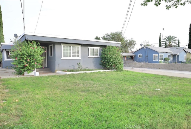 ranch-style home featuring a front yard