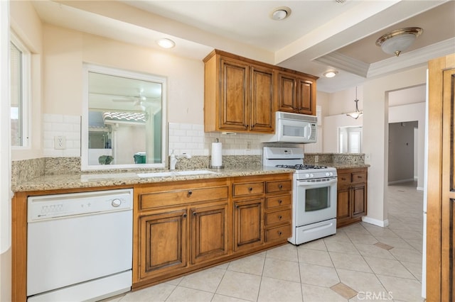 kitchen with backsplash, sink, white appliances, light stone countertops, and light tile patterned floors