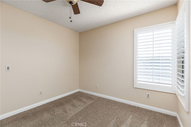 carpeted spare room featuring ceiling fan and a textured ceiling