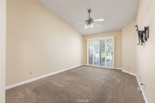 carpeted empty room featuring ceiling fan, a textured ceiling, and lofted ceiling