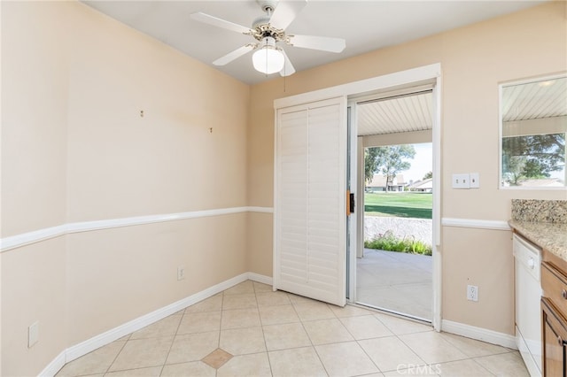 doorway featuring ceiling fan and light tile patterned floors