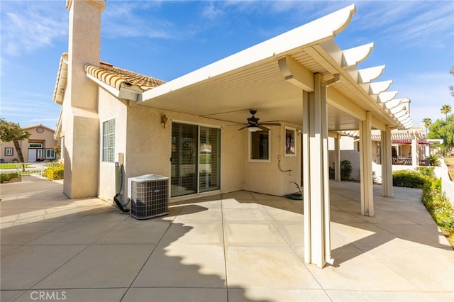 rear view of house with ceiling fan, a patio, and central AC