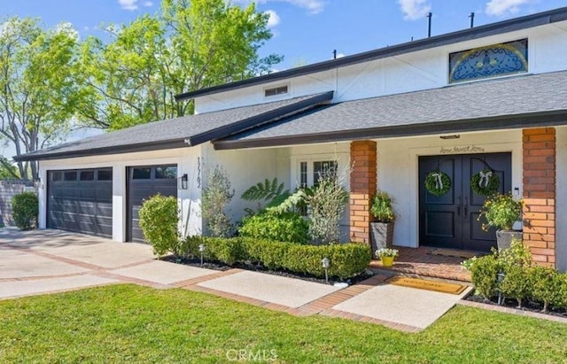 view of front of property with a front yard and a garage